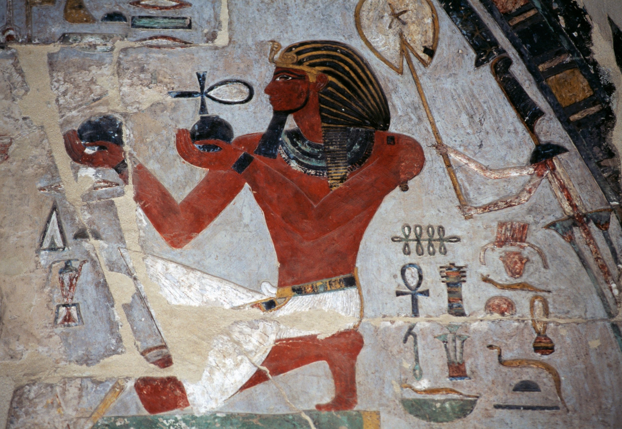 An ancient egyptian wall painting depicts a pharaoah offering wine