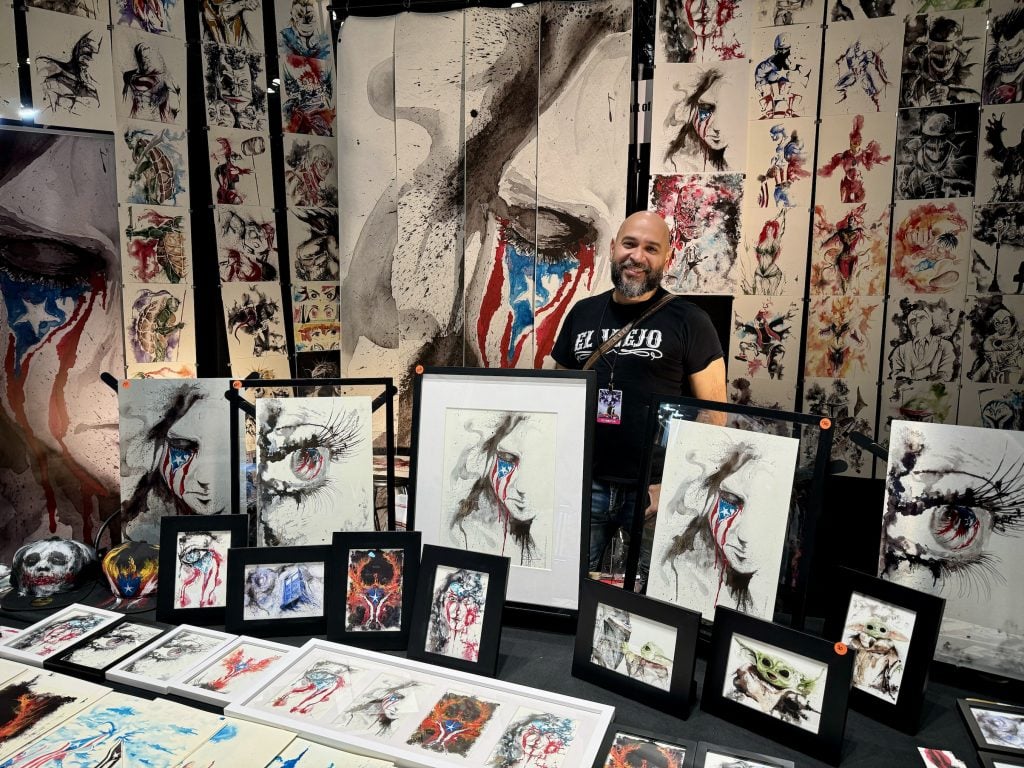 JaCo Tartaruga with his work at 2023 New York Comic Con. Photo by Sarah Cascone.