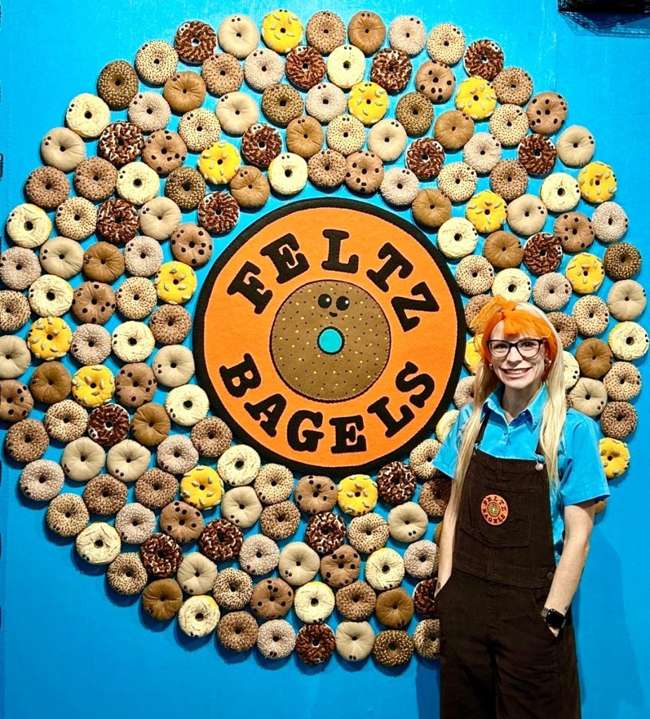 Lucy Sparrow at "Feltz Bagels," her new New York City bagel shop art show. Photo courtesy of the artist.