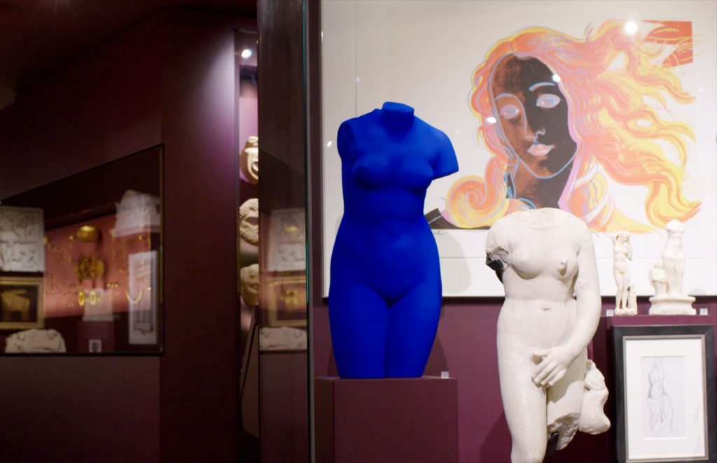 A selection of works from Christian Levett's collection at the Mougins Museum of Classical Art in France, including detail of Yves Klein, <em>Blue Venus</em> (1962/1982); a Roman marble torso of Venus (first to third century C.E.); and Andy Warhol, <em>Birth of Venus</em> (1984). Photo courtesy of the Mougins Museum. 