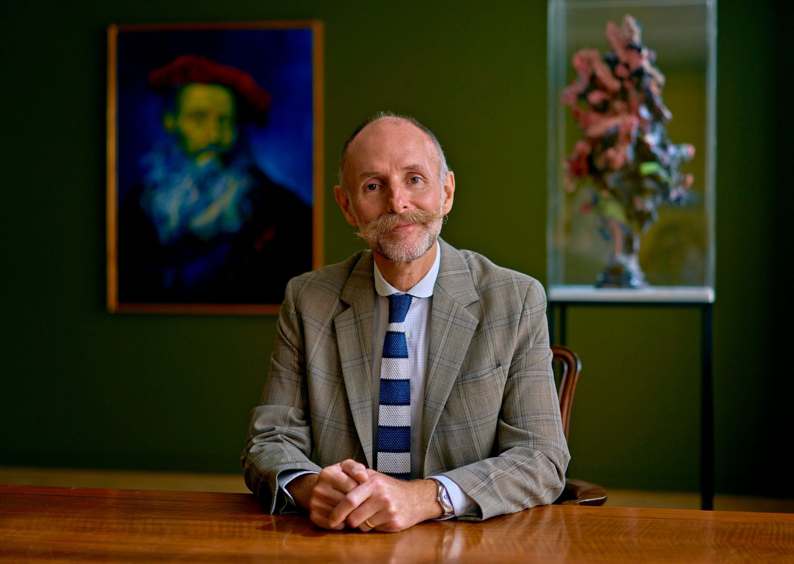 Portrait of Glenn at the Brown Collection, with his oil on panel Reproduction (2014) and his sculpture Valles Marineris (2020), oil and acrylic over stainless steel. Photo: Tom Jamieson. Courtesy of Glenn Brown.