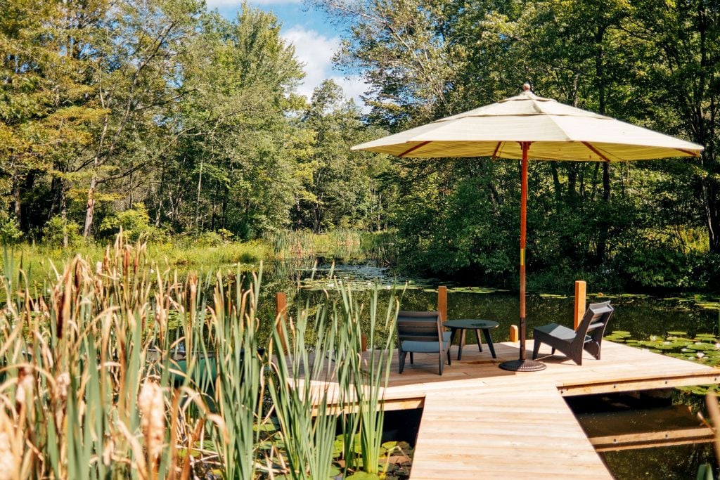 A pond with a dock on the property. Photo: Gabriel Zimmer / Catskill Image. Courtesy of Compass.