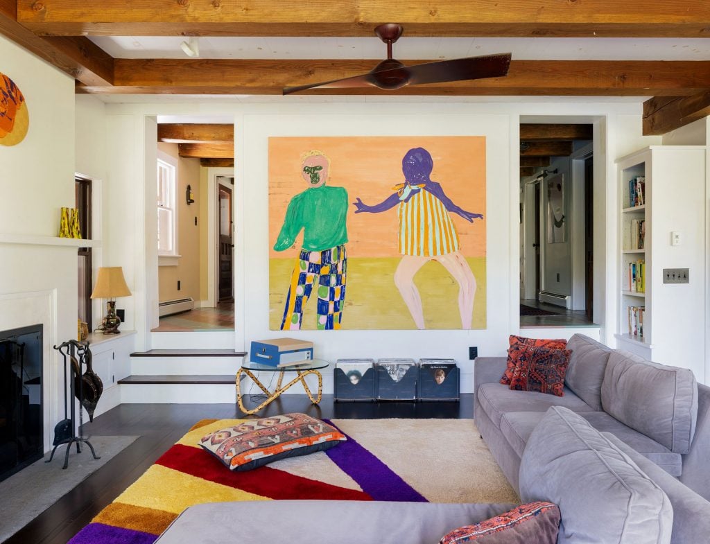 The living room of Gary Hume and Georgie Hopton's upstate New York home, with Nicola Tyson's <em>Two Figures Touching</em> (2011) on the wall. Courtesy of Compass.