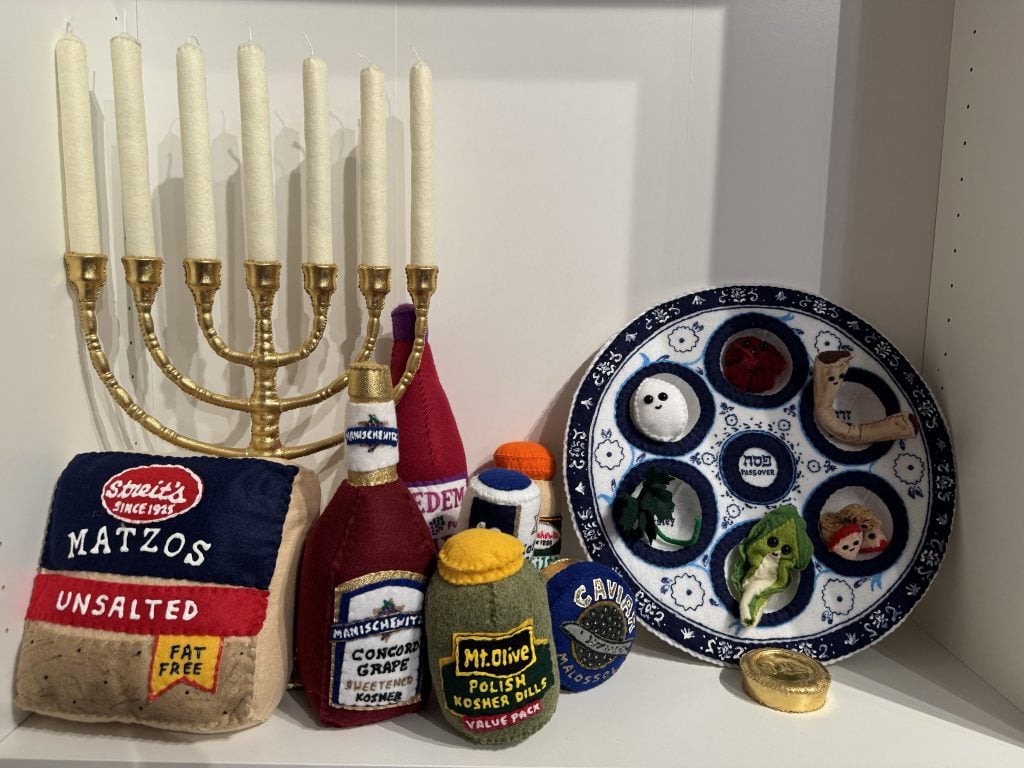 Lucy Sparrow's felted menorah and seder plate at "Feltz Bagels," her new New York City bagel shop art show. Photo by Sarah Cascone.