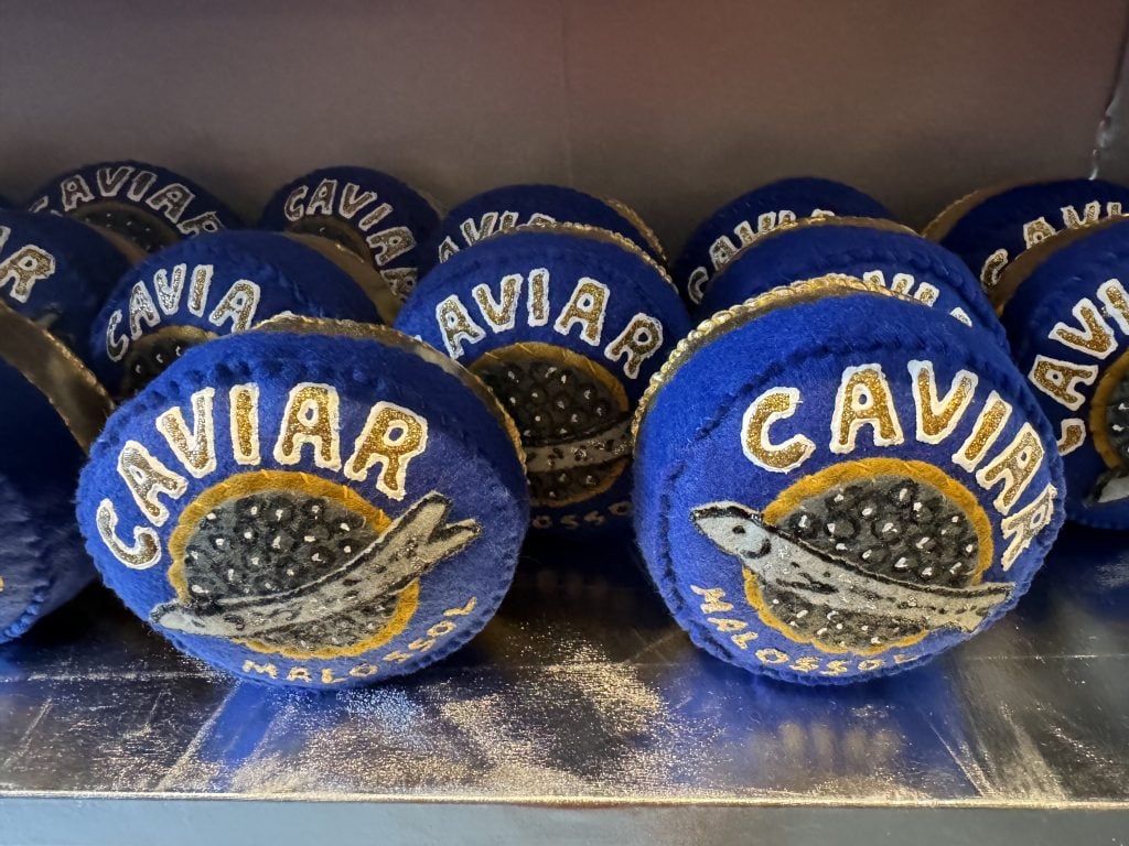 Lucy Sparrow's felted caviar tins at "Feltz Bagels," her new New York City bagel shop art show. Photo by Sarah Cascone.