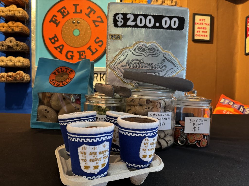 Lucy Sparrow's felted cash register and coffee at "Feltz Bagels," her new New York City bagel shop art show. Photo by Sarah Cascone. 