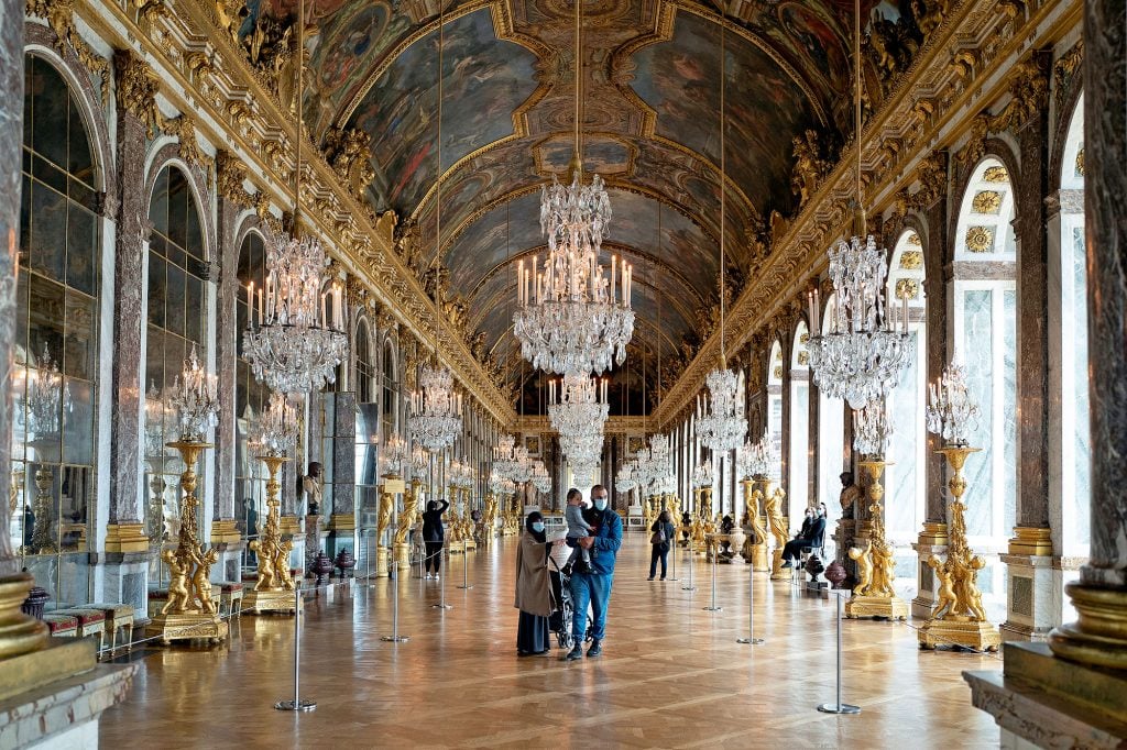 Visitors in the hall of mirrors at the reopening of Chateau de Versailles on May 19, 2021 in Versailles, France. (Photo by Aurelien Meunier/Getty Images)