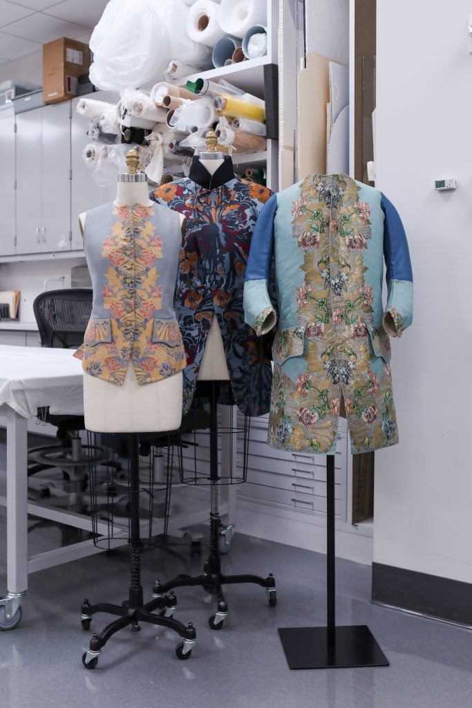 Vivienne Westwood, Waistcoat,  (1955); Isabel Shults Fund, 2002. Felix Chabluk Smith, Coat, (2013); Purchase, Gould Family Foundation Gift, in memory of Jo Copeland, 2014. Textile designed by Anna Maria Garthwaite and manufactured by Peter Lekeux, Waistcoat, (1747); Purchase, Irene Lewisohn Bequest, 1966. Photo courtesy of the Metropolitan Museum of Art, BFA.com/Hippolyte Petit.