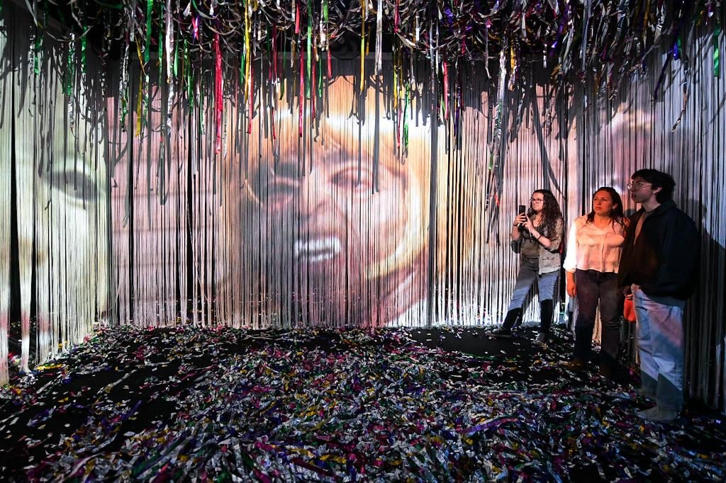 Visitors wade in the confetti in Mapa Teatro's installation. Courtesy of Artbo.