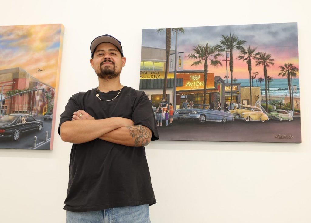 Gustavo Zermeño Jr. in front of his work at the opening of the group show "Under Pressure" at Beyond The Streets gallery in Los Angeles. Photo by Stewart Cook.