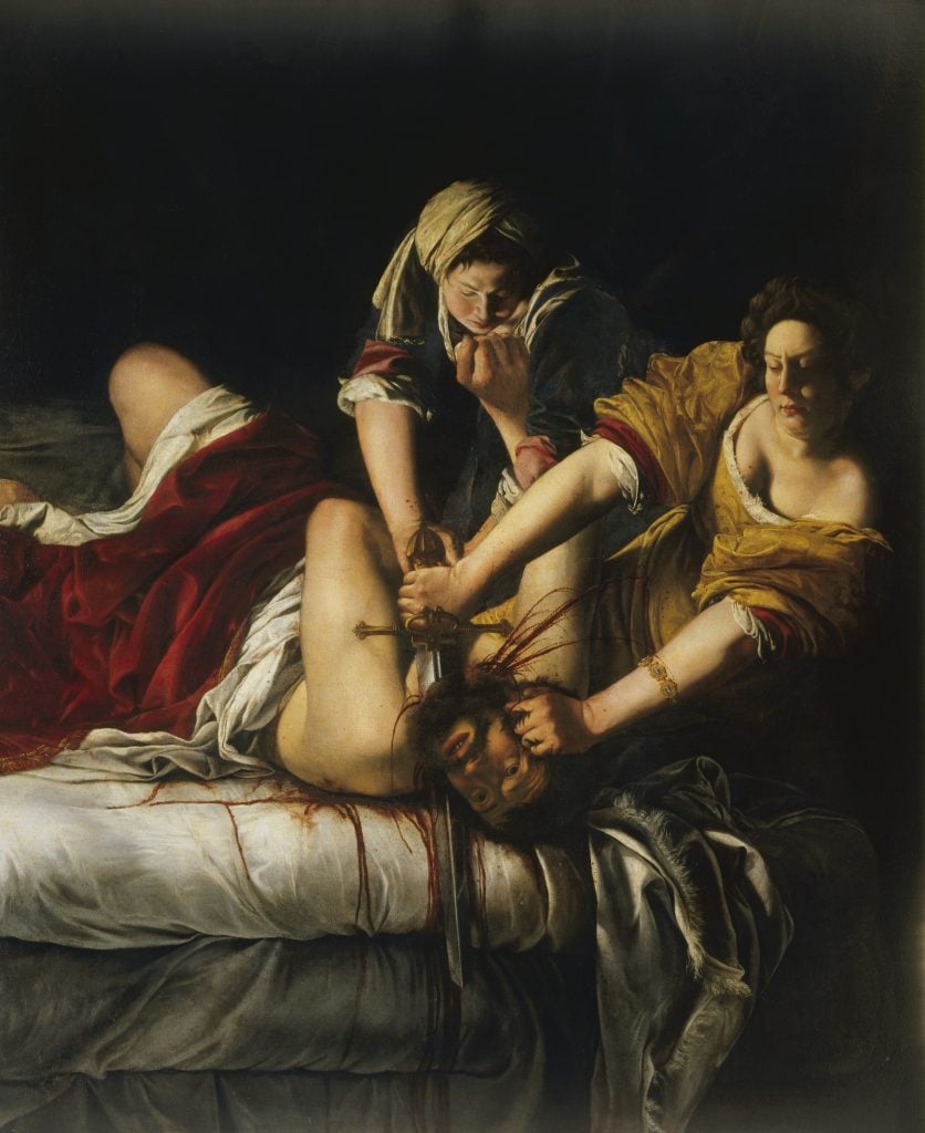 A painting by Artemisia Gentileschi called Judith Slaying Holofernes. Two women hold down a man and use a sword to cut off his head. They are lit against a dark background