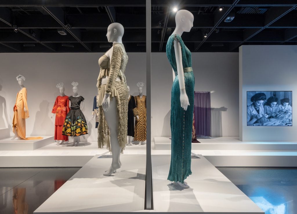 Gallery view, "Absence | Omission." Left: Dress by Ester Manas and Balthazaar Delpierre for Ester Manas 2022. Right: "Delphos" gown, Adèle Henriette Elisabeth Nigrin Fortuny and Mariano Fortuny for Fortuny ca. 1932. Photo: © The Metropolitan Museum of Art.