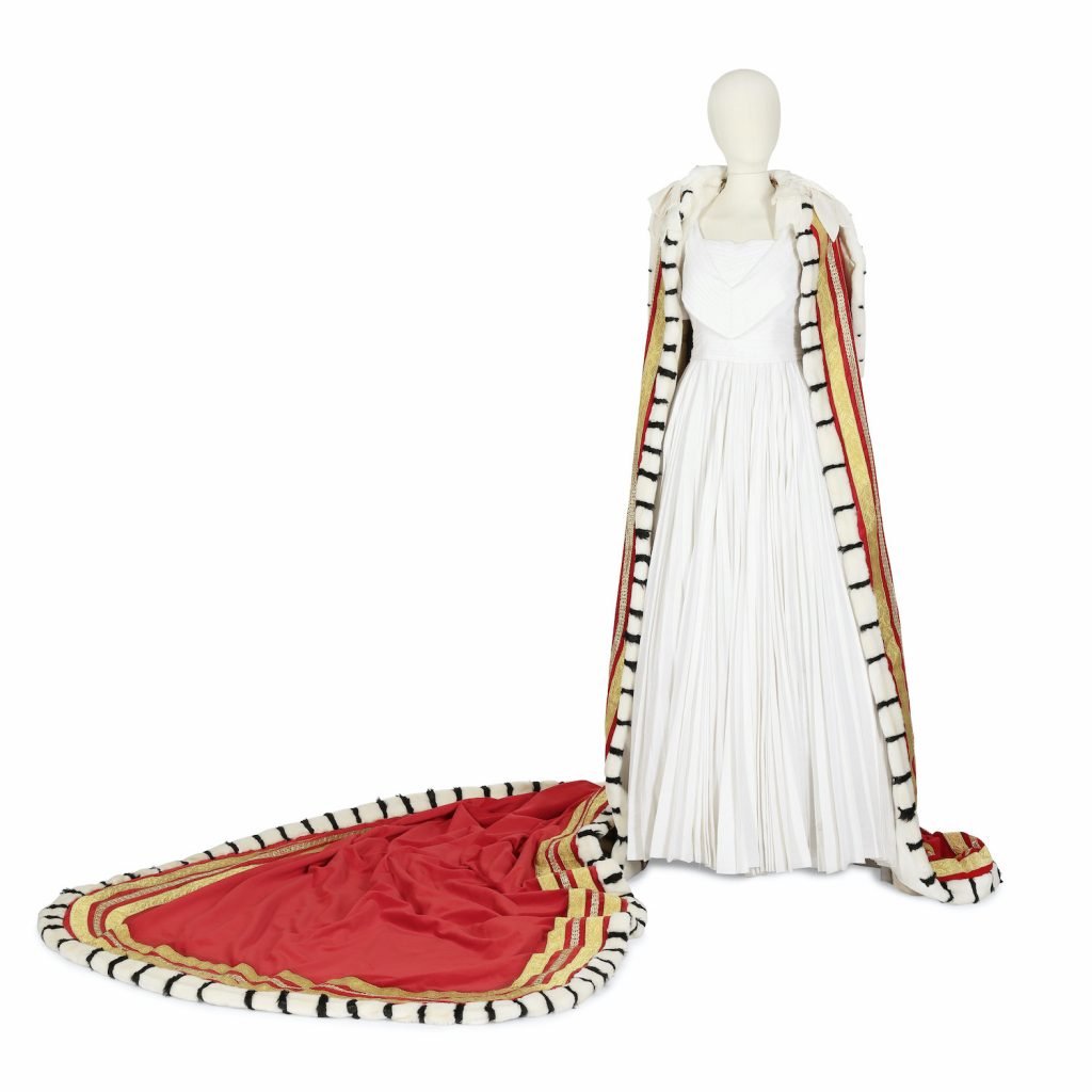 A reproduction of the Coronation ordaining dress, gold mantle, and red cloak worn on Season 1 Episode 5. Photo via Bonhams.