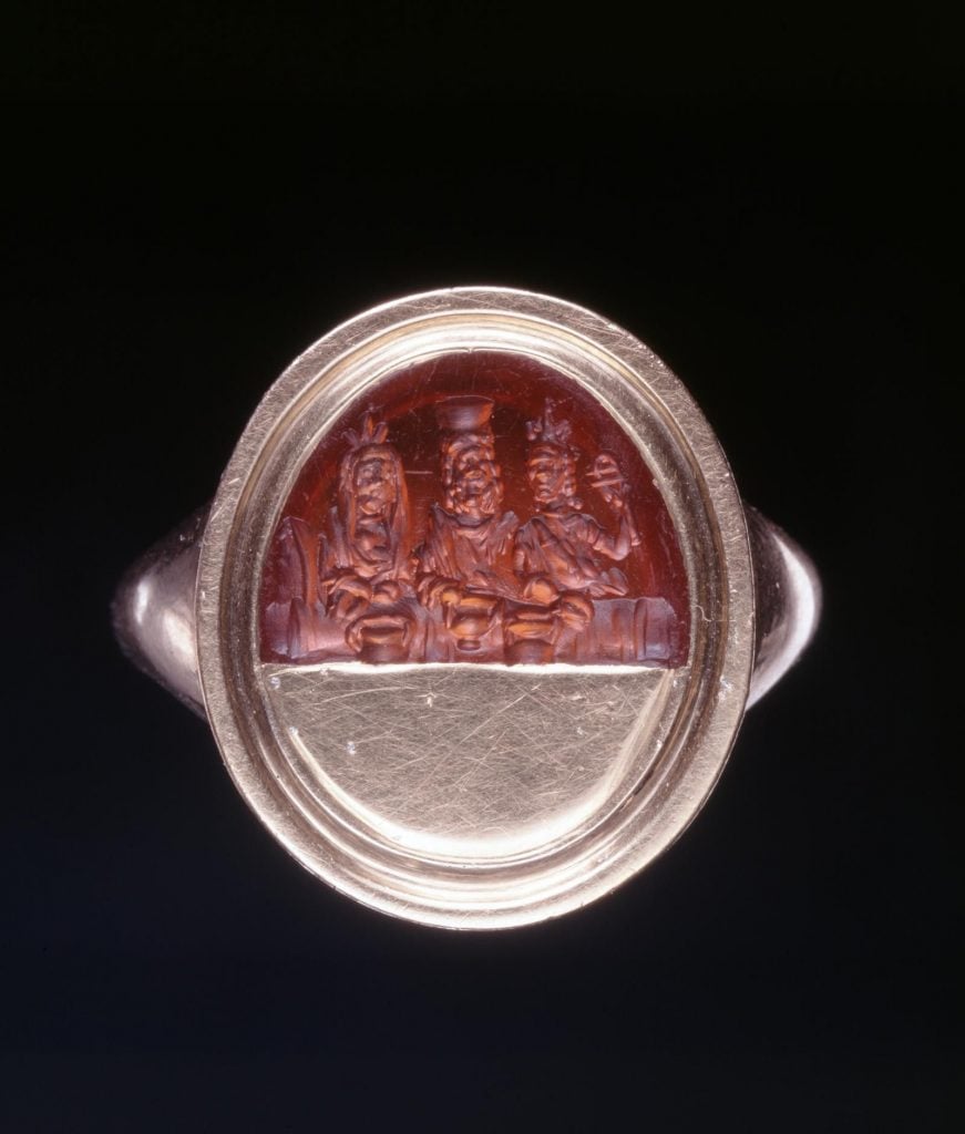 A sard gem engraved with depictions of Sarapis and Isis. Photo courtesy of the British Museum.