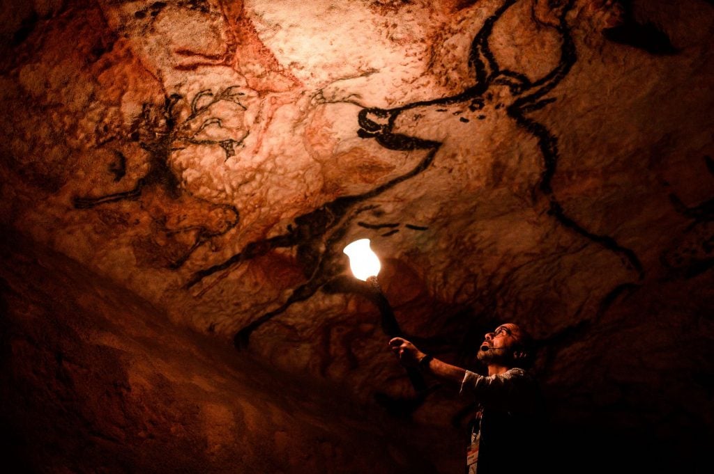 Employee in the Lascaux Cave Replica (2022). Photo by Philippe Lopez / AFP via Getty Images.