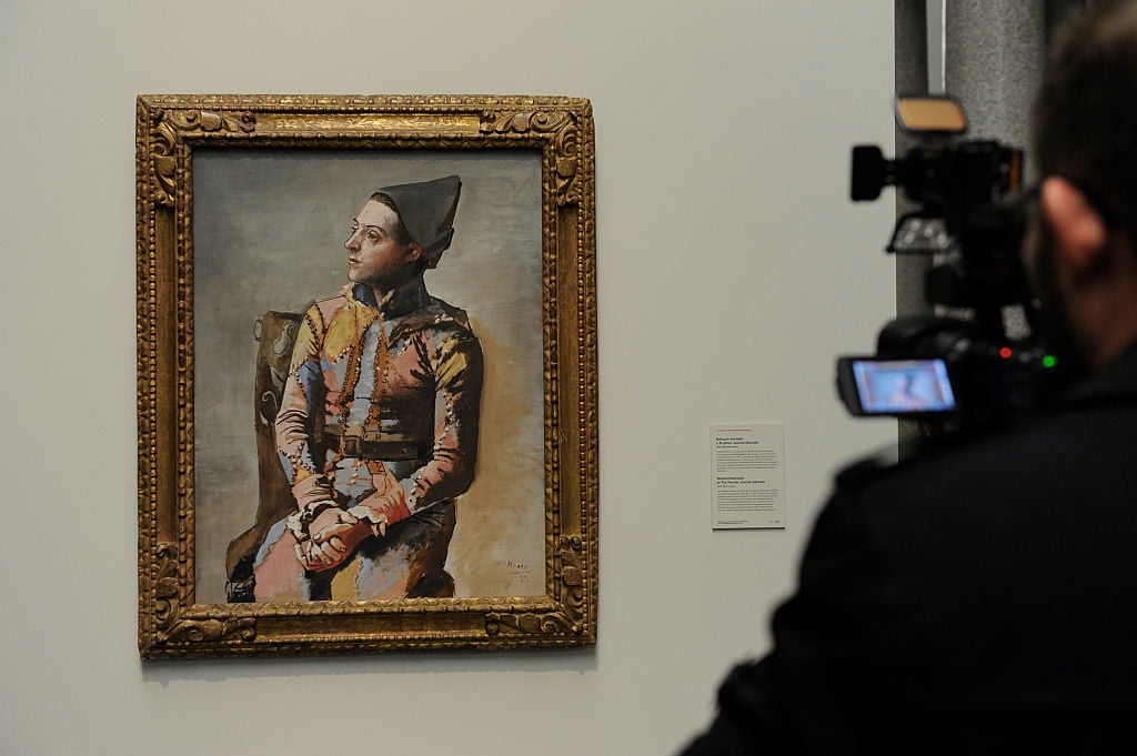 <i>Seated Harlequin</i> by Pablo Picasso on loan from the Kunstmuseum Basel to the Prado Museum in 2015. Photo by Quim Llenas/Getty Images.