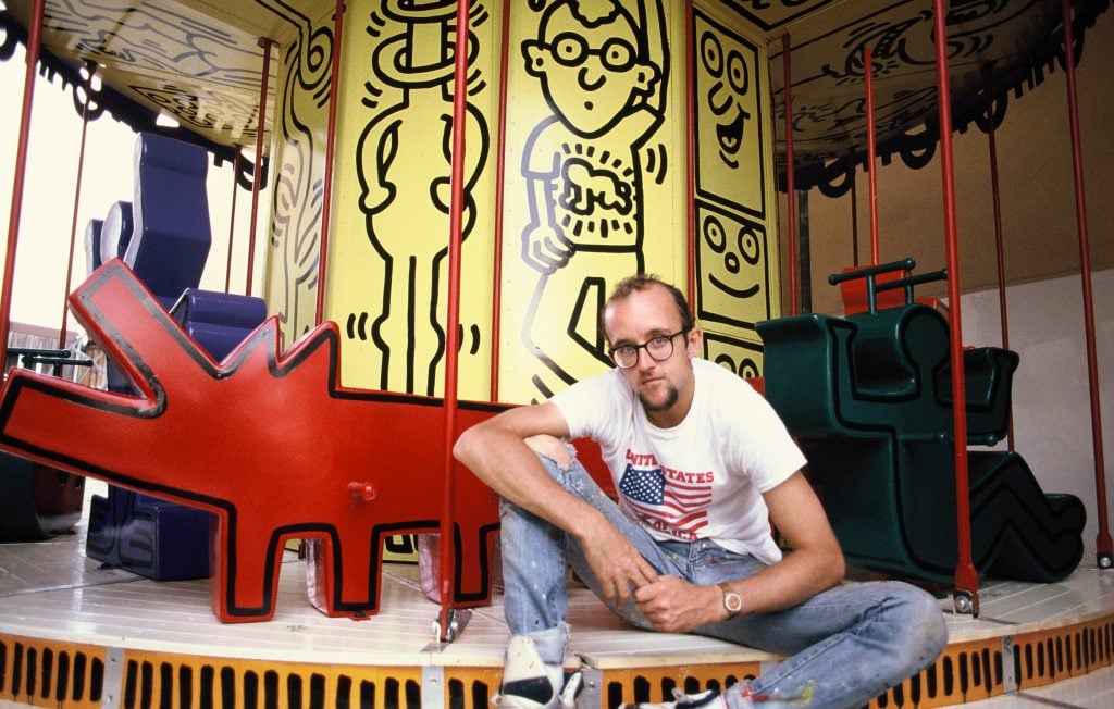 Keith Haring alongside his painted carousel for Luna Luna, 1987. Photo: Sabina Sarnitz.
