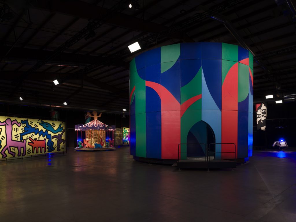 Installation view of "Luna Luna: Forgotten Fantasy," featuring Keith Haring's painted carousel and David Hockney's Enchanted Tree. Photo: Jeff McLane.