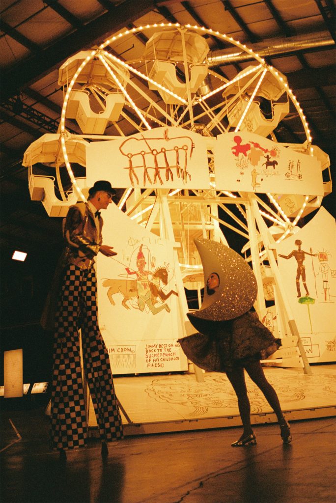 Performers alongside Jean-Michel Basquiat's painted Ferris wheel at "Luna Luna: Forgotten Fantasy." Photo: Sarah Mathison.