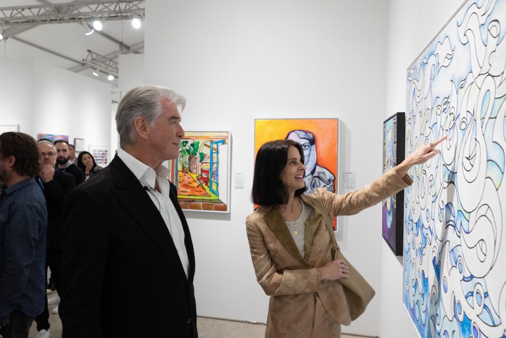 Pierce Brosnan with art advisor Joyce Varvatos on the opening night of Art Miami with his painting.