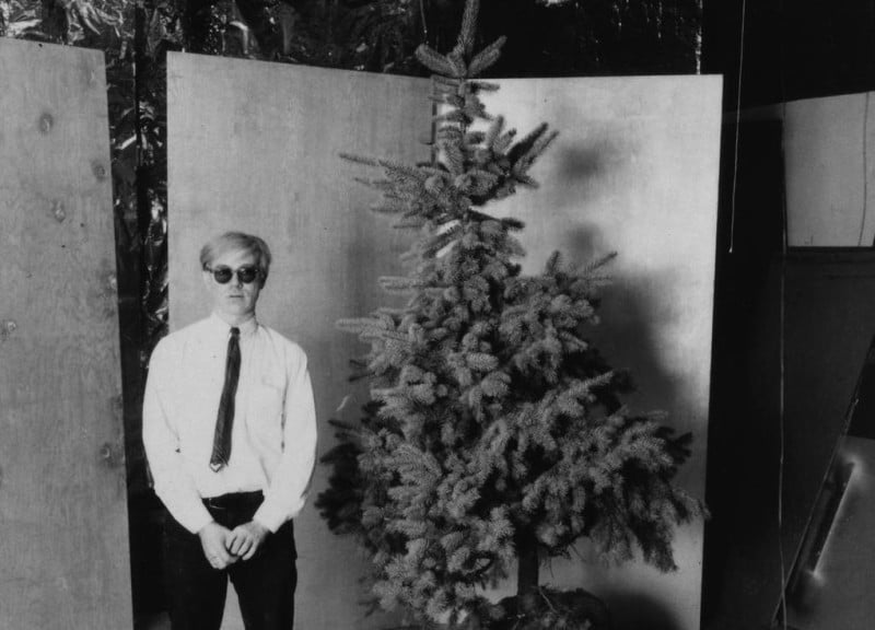 Unknown photographer, Andy Warhol and his Christmas tree in the Factory (1964). Courtesy of the Andy Warhol Museum.