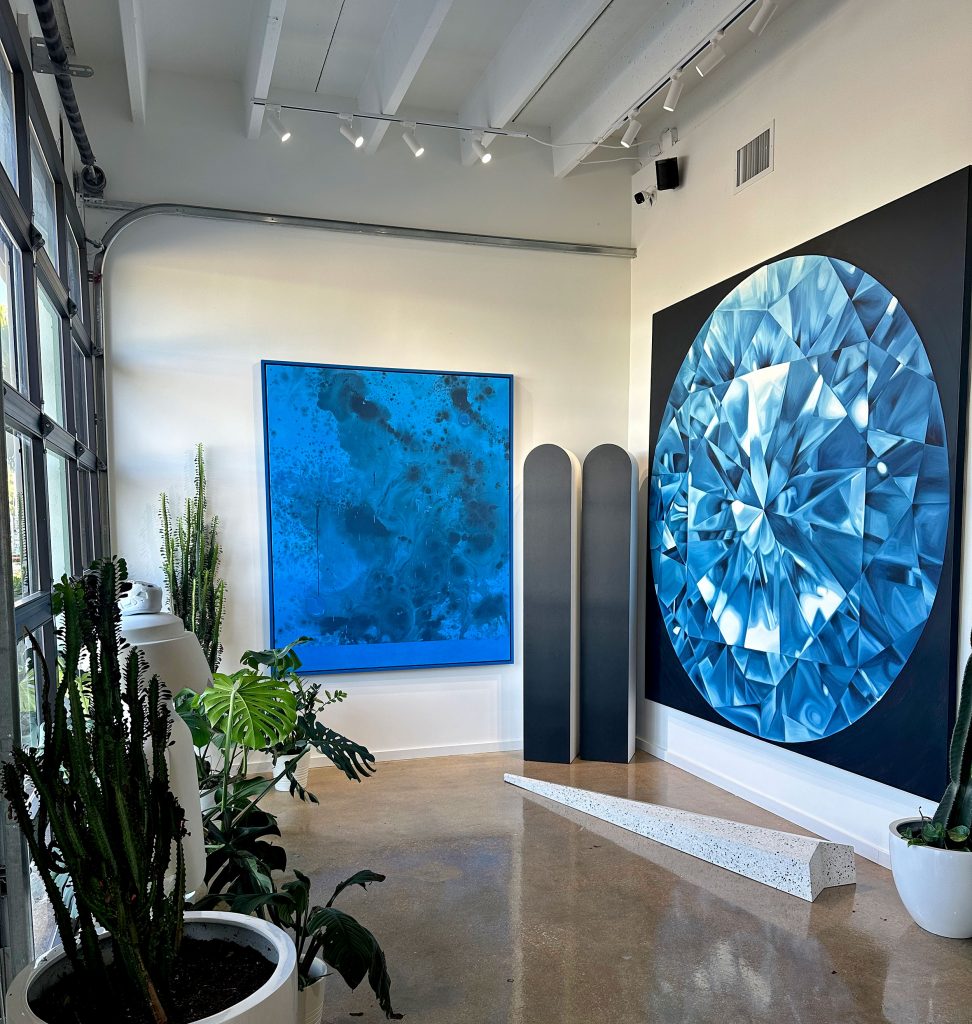 Artworks in Jack Benmeleh's office (left to right) by Sayre Gomez (blue painting), Math Bass (twin towers), Nick Lobo (sloping sculpture), and Bhakti Baxter (blue diamond). 