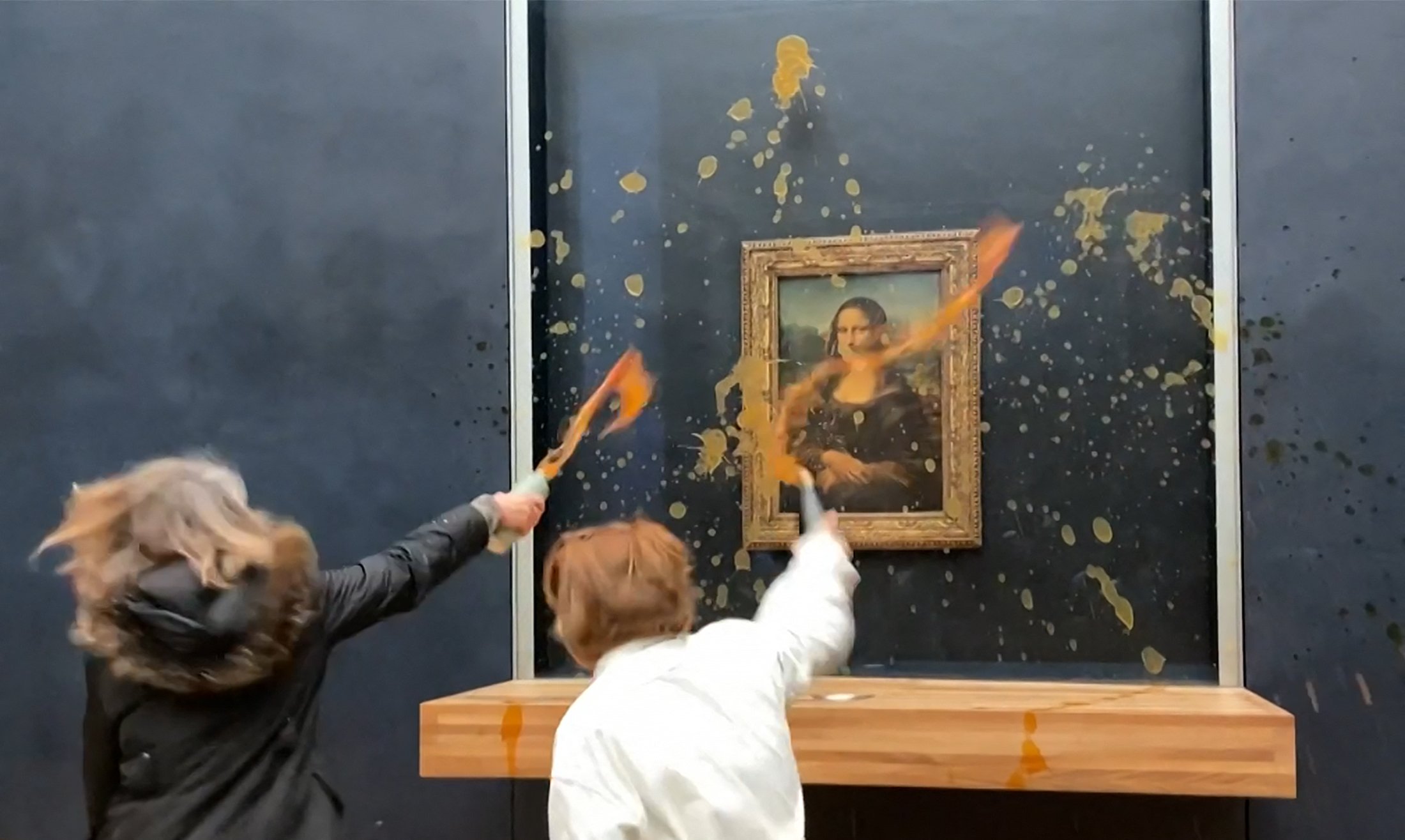 Two environmental activists from the collective "Riposte Alimentaire" hurled soup at Leonardo Da Vinci's "Mona Lisa" at the Louvre museum in Paris, on January 28, 2024.