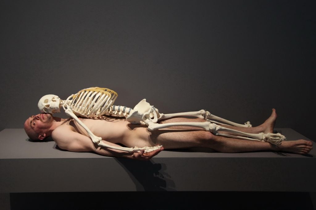 Performer John Bonafede lies nude underneath a skeleton in the 2010 retrospective "Marina Abramović: The Artist Is Present" at the Museum of Modern Art.