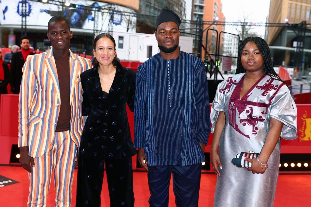 Gildas Adannou, Mati Diop, Habib Ahandessi, and Joséa Guedje at the "Dahomey" premiere during the 74th Berlinale International Film Festival .