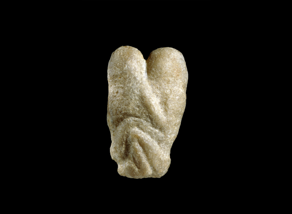 photograph of a Phallic figurine carved in stone
