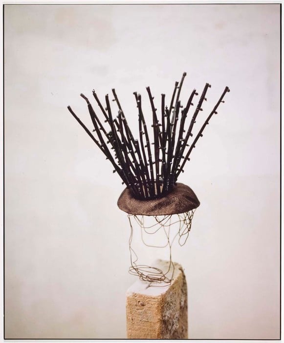 photograph of a hat with sticks protruding from the top by balenciaga circa 1988