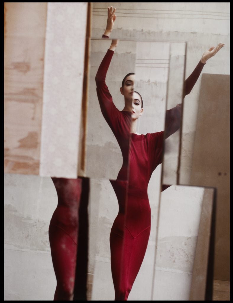 David Seidner photograph of a francine howells reflection in multiple mirrors wearing a maroon longsleeve alaia dress