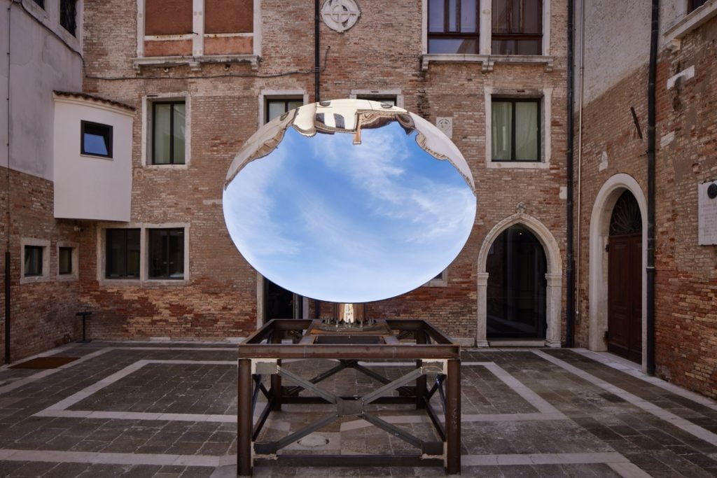 a concave mirror in a courtyard in Venice