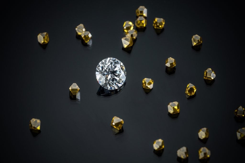 a few shiny diamonds scattered over a black surface