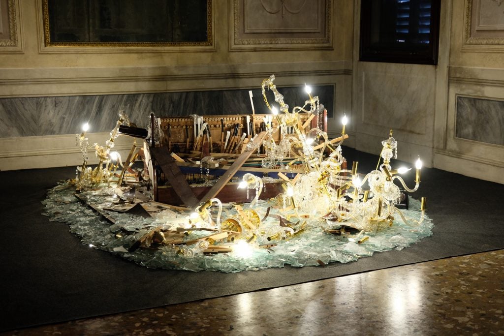 an artwork made of shattered chandelier crashed on a piano in a historic Italian building