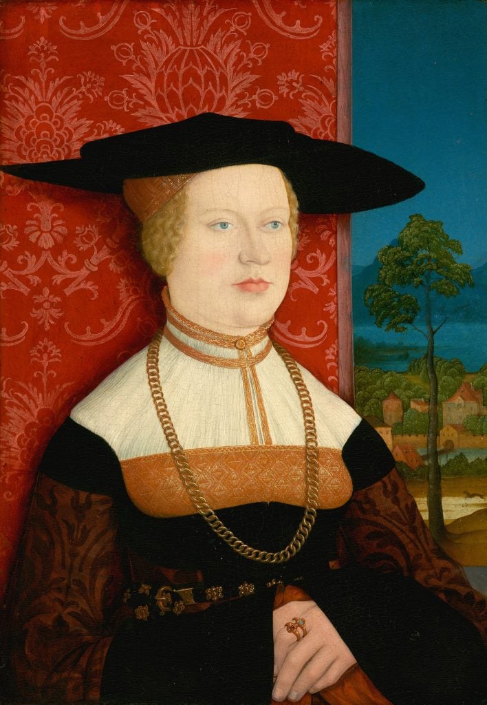 A 16th-century painting of a woman dressed in finery, a large hat, and a huge necklace around her neck.