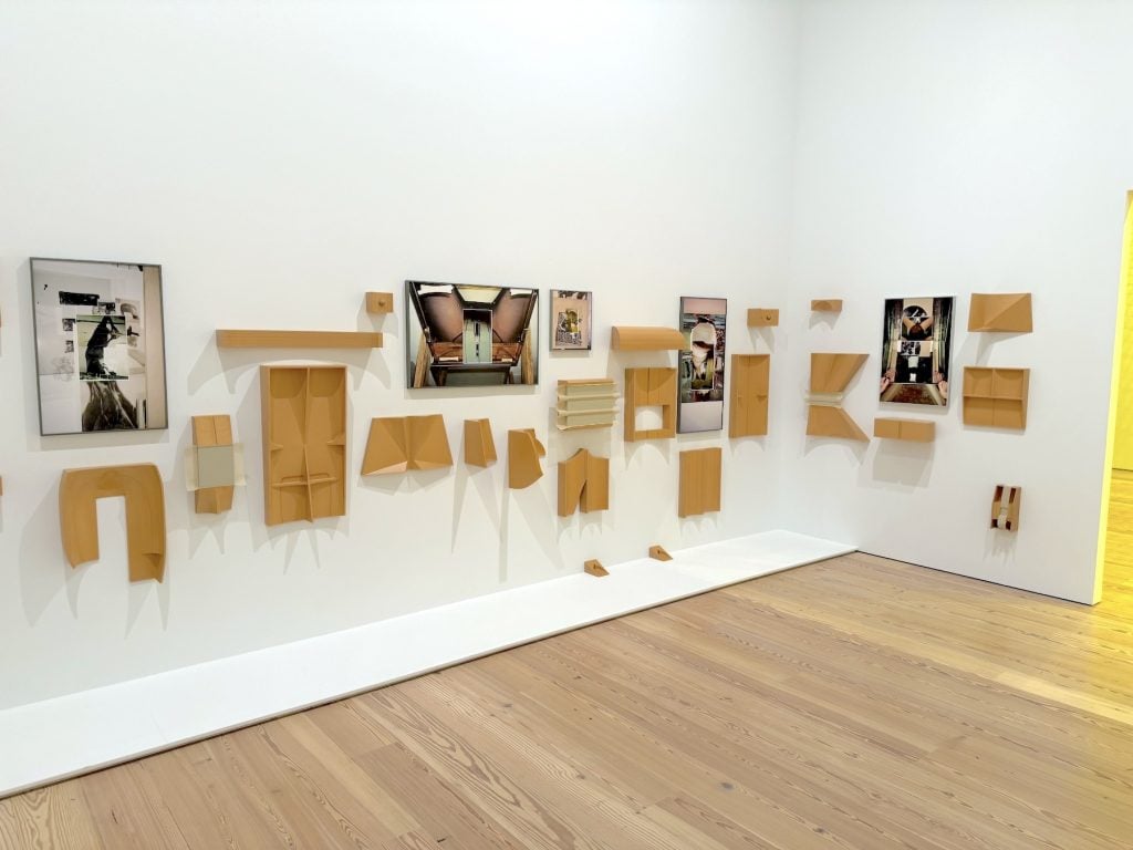 A gallery wall filled with various small sculpture and photos