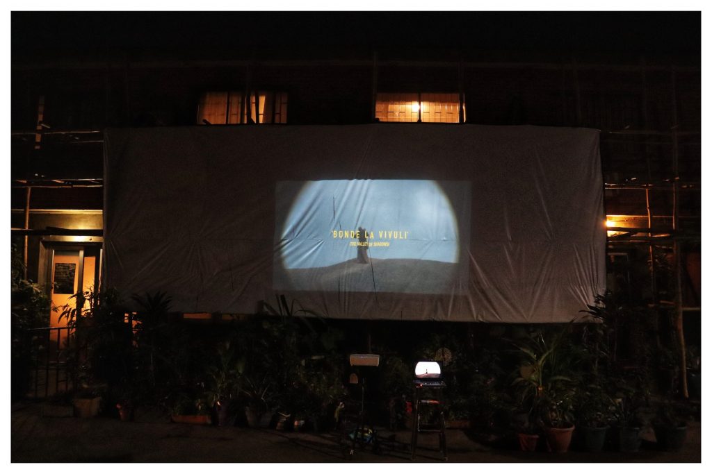 A movie being projected onto a sheet