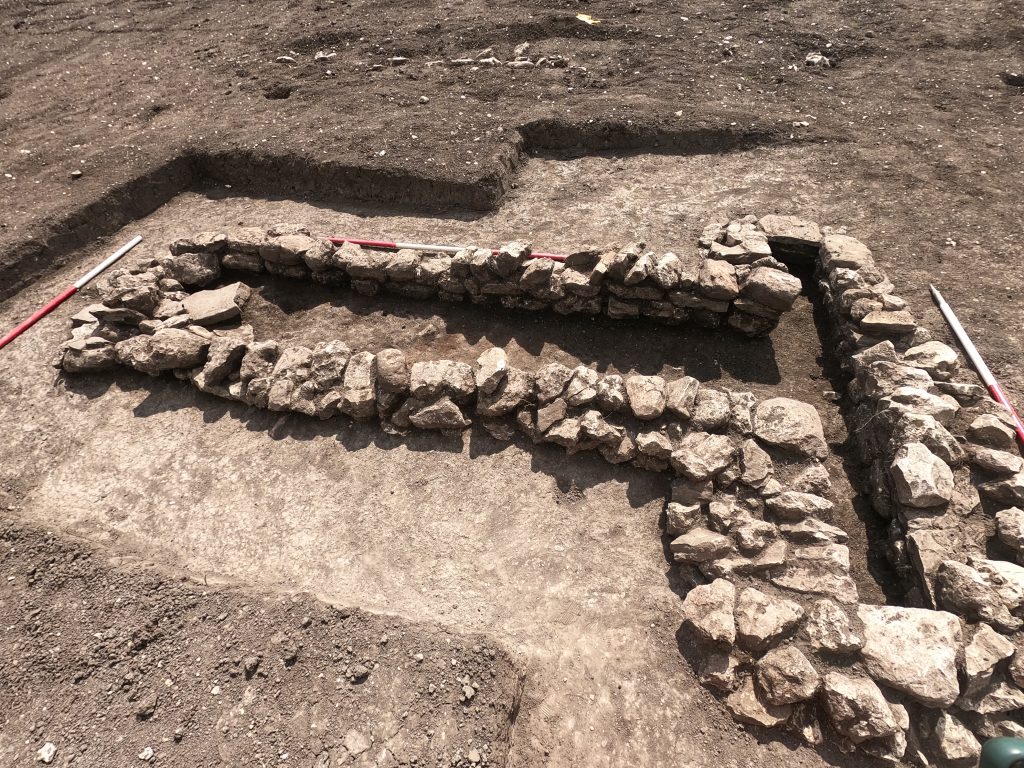 An ancient Roman oven built with irregular stones.