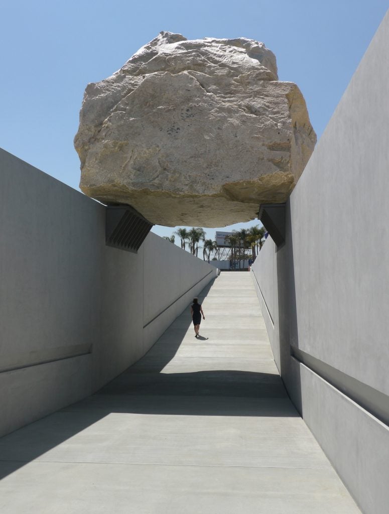 Michael Heizer's artwork "Levitated Mass," in which a 340-ton boulder is perched atop a trench dug in the ground.