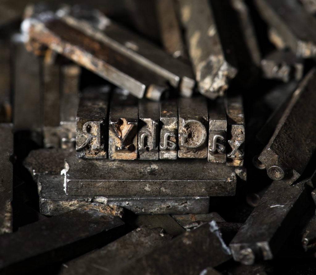 metal pieces of letterpress Doves Type in a pile