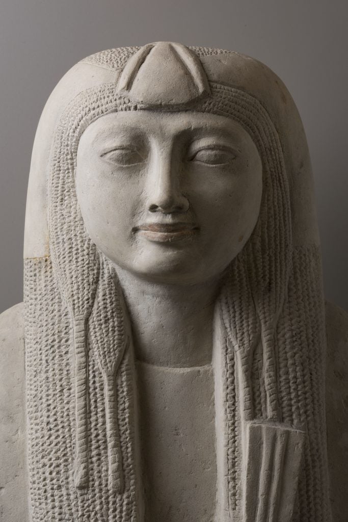 An ancient Egyptian statue of a woman with flowing hair