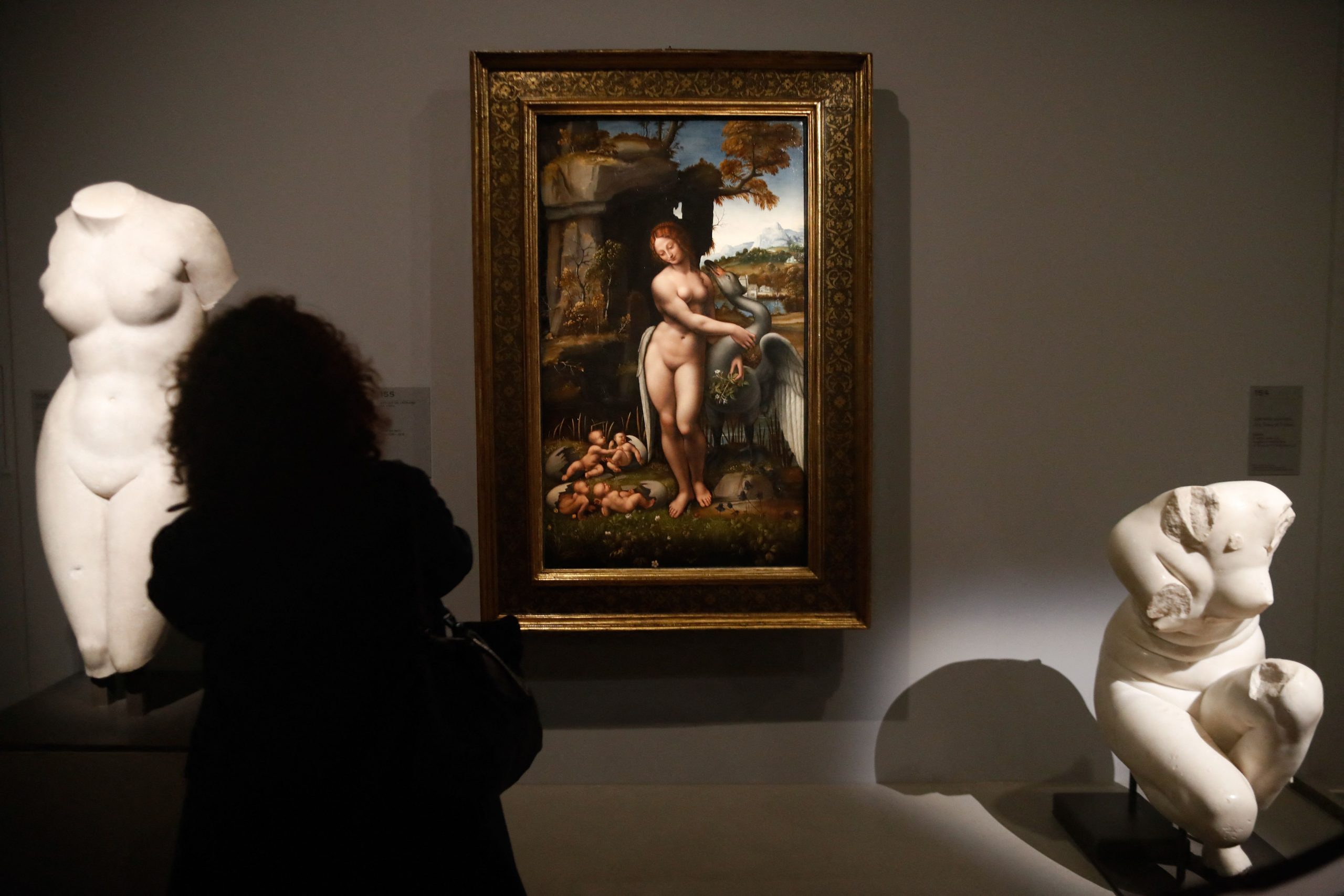 A gallery hung with the painting "Leda and the Swan" and flanked by two sculptures.