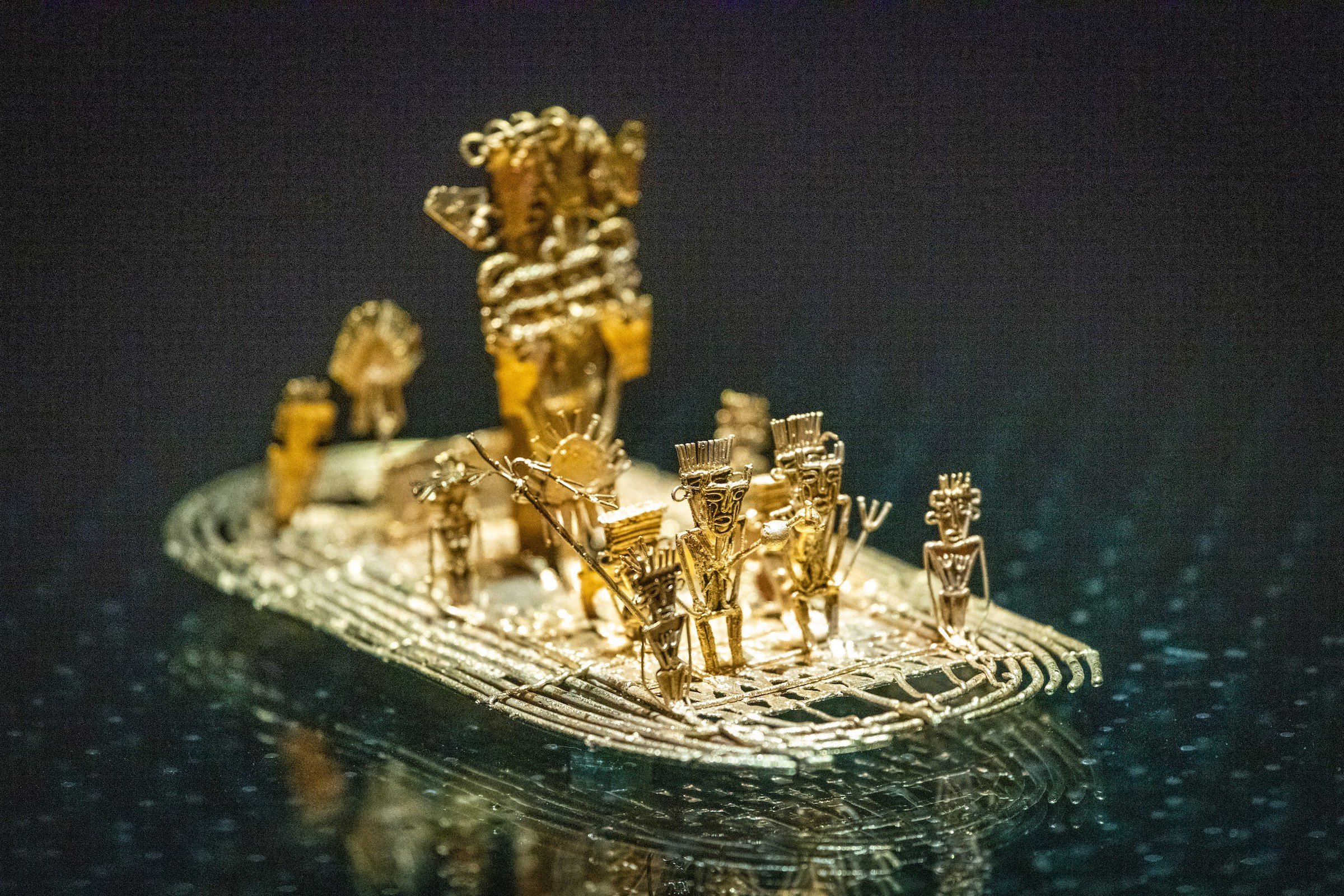 Gold artifacts depicting small human figures.