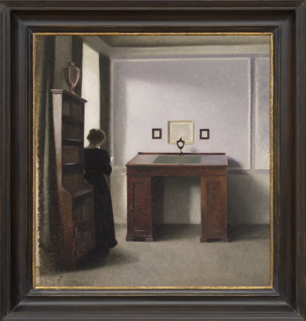 The image is a painting featuring a person in a room. The room includes a picture frame, mirror, and art on the wall, with a visible floor.