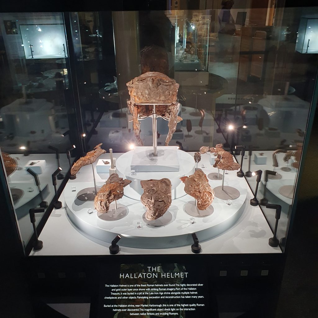 An ancient Roman helmet in a display case.