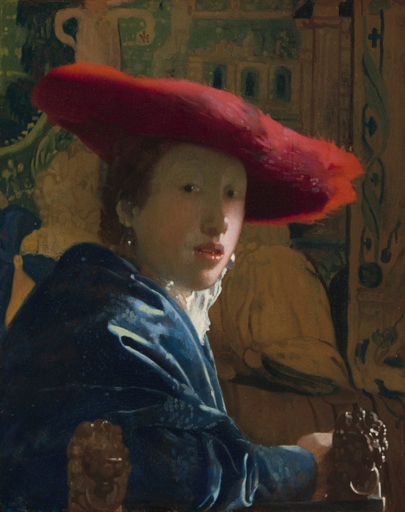  "Girl with a Red Hat" is a renowned painting by the Dutch artist Johannes Vermeer, believed to have been created around 1665. In this masterpiece, a young girl is depicted wearing a striking red hat adorned with a delicate white feather. Her face is illuminated softly by light, and she gazes directly at the viewer with a serene expression. The background is a dark, neutral tone, emphasizing the vividness of the girl's attire and her captivating presence. Vermeer's meticulous attention to detail and his skillful use of light and shadow contribute to the overall charm and allure of the painting.