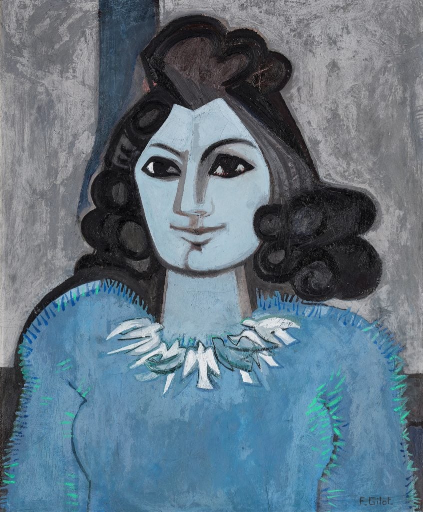 A color photo displays a painting of a woman that is largely blue and gray. Her skin and dress are various shades of gray.