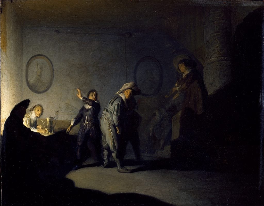 In this work, Rembrandt presents a scene set within an interior space, likely depicting everyday life in 17th-century Amsterdam. The painting features several figures engaged in various activities, each rendered with Rembrandt's characteristic attention to detail and psychological insight. The play of light and shadow enhances the drama of the scene, casting areas of brightness and darkness across the composition.
