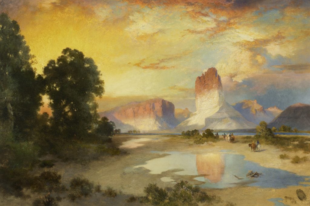 Thomas Moran's painting of the Green River in Wyoming depicts a vast, rugged landscape with winding waters cutting through towering cliffs and vibrant greenery, capturing the essence of the American West in vivid detail.
